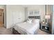 Guest bedroom with a gray upholstered bed and double doors at 32660 Rustic Rise Rd, San Antonio, FL 33576