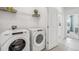 Laundry room with Whirlpool washer and dryer, and shelving at 32660 Rustic Rise Rd, San Antonio, FL 33576