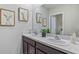 Bathroom with double vanity, speckle countertops, and framed art at 35174 Valley Ridge Rd, Dade City, FL 33525
