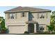 Two-story house with light beige siding, shutters, and a large garage at 35174 Valley Ridge Rd, Dade City, FL 33525