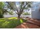 Spacious backyard with brick patio and large oak tree at 3616 W Morrison Ave, Tampa, FL 33629
