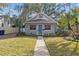 Gray house with blue door, landscaped lawn, and walkway at 3616 W Morrison Ave, Tampa, FL 33629
