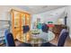 Bright dining area with a glass table and wooden hutch at 4113 Barret Ave, Plant City, FL 33566