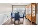 Charming dining area with glass table and four blue chairs at 4113 Barret Ave, Plant City, FL 33566