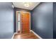 Bright entryway with hardwood floors and a wooden door at 4113 Barret Ave, Plant City, FL 33566