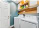 Laundry room with washer, dryer, and overhead cabinets at 4113 Barret Ave, Plant City, FL 33566