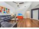 Spacious living room with hardwood floors, a ceiling fan, and leather furniture at 4113 Barret Ave, Plant City, FL 33566