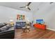Spacious living room with hardwood floors, a ceiling fan, and leather furniture at 4113 Barret Ave, Plant City, FL 33566