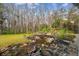 Serene backyard with a pond, bridge, and lush landscaping at 4825 Scott Rd, Lutz, FL 33558