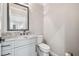 Modern bathroom with granite countertop vanity and gray cabinetry at 4825 Scott Rd, Lutz, FL 33558
