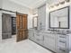 Bathroom with double vanity, granite countertops and barn door at 4825 Scott Rd, Lutz, FL 33558