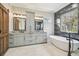 Bathroom with freestanding tub, double vanity, and walk-in shower at 4825 Scott Rd, Lutz, FL 33558