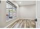 Bright bedroom with large window and wood-look tile floors at 4825 Scott Rd, Lutz, FL 33558