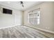 Spacious bedroom with wood-look tile floors and large window at 4825 Scott Rd, Lutz, FL 33558