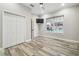 Bedroom with large window, double doors to closet and pool view at 4825 Scott Rd, Lutz, FL 33558