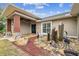 Home entrance with a stone patio, decorative water fountain, and landscaping at 4825 Scott Rd, Lutz, FL 33558