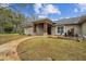 House exterior showcasing stone pathway, landscaping, and a water feature at 4825 Scott Rd, Lutz, FL 33558