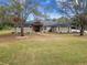House exterior with a manicured lawn and landscaping at 4825 Scott Rd, Lutz, FL 33558