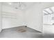 Unfinished garage room with shelving and access to the garage at 4825 Scott Rd, Lutz, FL 33558