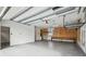 Spacious garage with overhead storage and workbench at 4825 Scott Rd, Lutz, FL 33558
