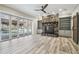 Gathering room features a stone fireplace, built-in shelving, and pool view at 4825 Scott Rd, Lutz, FL 33558