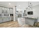 Spacious kitchen with gray cabinets, granite island, and wood floors at 4825 Scott Rd, Lutz, FL 33558