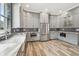 Modern kitchen with gray cabinets, granite countertops, and stainless steel appliances at 4825 Scott Rd, Lutz, FL 33558