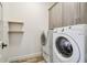 Bright laundry room with washer, dryer and built-in cabinets at 4825 Scott Rd, Lutz, FL 33558