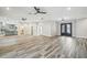 Open living space with wood-look tile floors and kitchen view at 4825 Scott Rd, Lutz, FL 33558