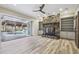 Gathering room with stone fireplace and access to the pool area at 4825 Scott Rd, Lutz, FL 33558