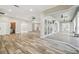 Bright living area with pool view and wood-look tile floors at 4825 Scott Rd, Lutz, FL 33558