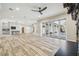 Open living area with large windows, pool view, and hardwood floors at 4825 Scott Rd, Lutz, FL 33558