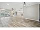 Open concept living room with tile floors and views of the pool at 4825 Scott Rd, Lutz, FL 33558