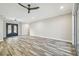 Spacious living room with wood-look tile floors and entryway at 4825 Scott Rd, Lutz, FL 33558