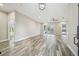 Spacious living room with wood-look tile floors and access to the pool area at 4825 Scott Rd, Lutz, FL 33558