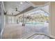 Open floor plan with glass doors leading to the pool at 4825 Scott Rd, Lutz, FL 33558