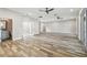 Spacious living room featuring wood-look tile floors and ceiling fans at 4825 Scott Rd, Lutz, FL 33558