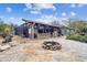 Outdoor kitchen and firepit area with flagstone patio at 4825 Scott Rd, Lutz, FL 33558