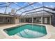 Large, refreshing pool with a screened enclosure and covered patio at 4825 Scott Rd, Lutz, FL 33558