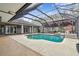Resort-style pool with covered patio and outdoor kitchen at 4825 Scott Rd, Lutz, FL 33558