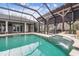 Relaxing pool and spa area with a covered patio and outdoor kitchen at 4825 Scott Rd, Lutz, FL 33558