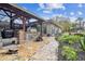 Outdoor stone patio with built-in grill and seating area at 4825 Scott Rd, Lutz, FL 33558