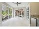 Bright sunroom with access to backyard patio, pool, and outdoor kitchen at 4825 Scott Rd, Lutz, FL 33558
