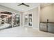 Sunroom with pool and patio view, featuring tile floors and sliding glass doors at 4825 Scott Rd, Lutz, FL 33558