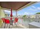 Relaxing balcony with table and chairs overlooking the water at 5005 Coquina Key Se Dr # E, St Petersburg, FL 33705