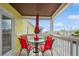 Balcony with red chairs and table overlooking marina at 5005 Coquina Key Se Dr # E, St Petersburg, FL 33705