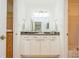 Bright bathroom with white vanity and granite countertop at 5005 Coquina Key Se Dr # E, St Petersburg, FL 33705