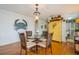 Bright dining room featuring a glass-top table and four chairs at 5005 Coquina Key Se Dr # E, St Petersburg, FL 33705