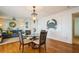 Open dining area with hardwood floors and a view of the living room at 5005 Coquina Key Se Dr # E, St Petersburg, FL 33705
