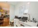 Home office with desk, printer, and view of living area at 5005 Coquina Key Se Dr # E, St Petersburg, FL 33705